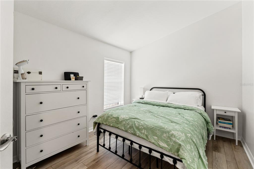 12310 Boot Spur Way Spring Hill, FL 34610 - Photo 26 of 36 a bedroom with a bed and a dresser