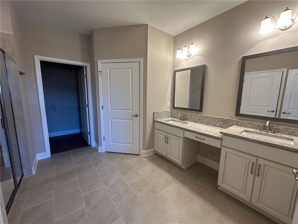 1001 Calypso Way, Unit 1001 Cumming, GA 30040 - Photo 14 of 27 a bathroom with a sink and a mirror
