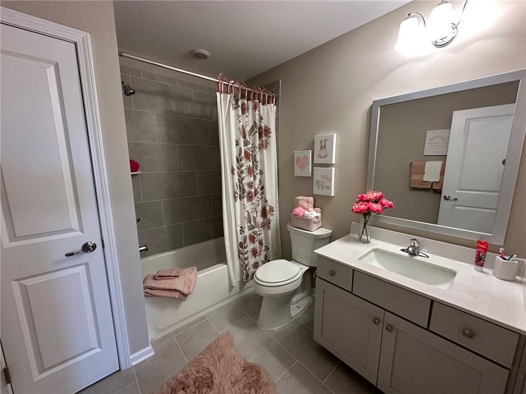 1001 Calypso Way, Unit 1001 Cumming, GA 30040 - Photo 21 of 27 a bathroom with a sink vanity mirror and toilet