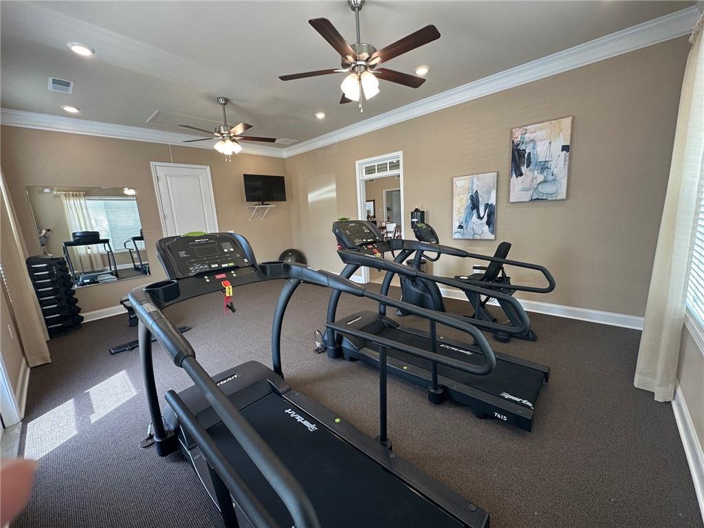 1001 Calypso Way, Unit 1001 Cumming, GA 30040 - Photo 26 of 27 a room with gym equipment and a view of living room