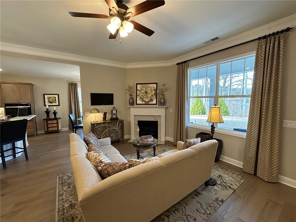 1001 Calypso Way, Unit 1001 Cumming, GA 30040 - Photo 7 of 27 a living room with furniture a fireplace and a flat screen tv