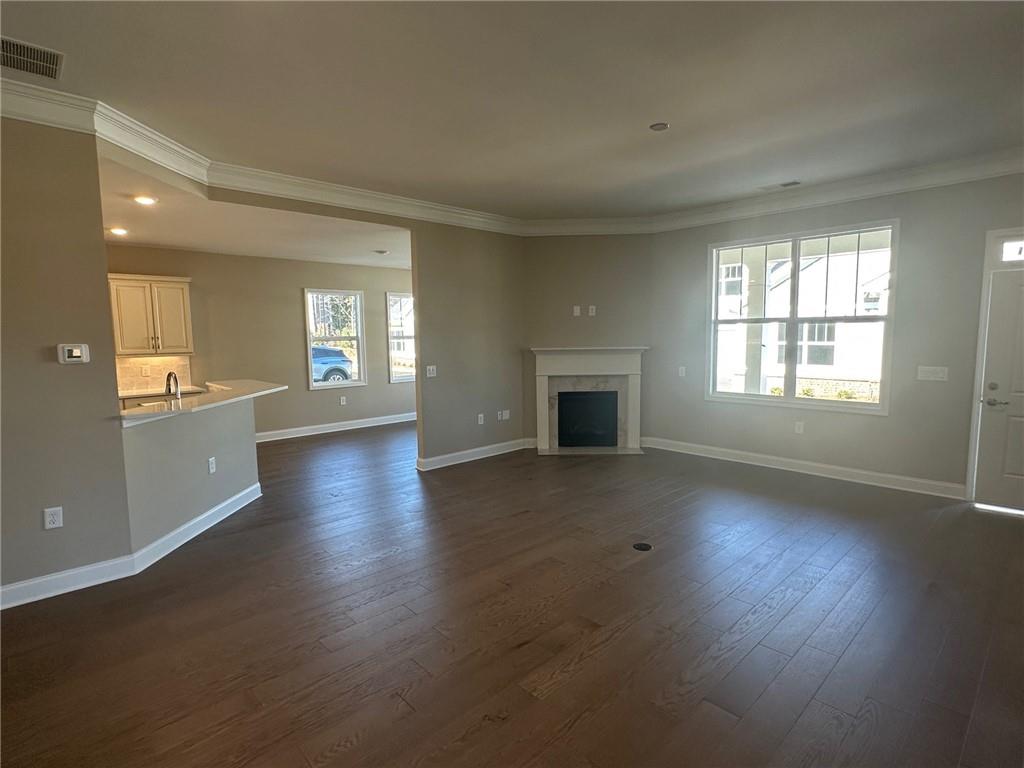 1001 Calypso Way, Unit 1001 Cumming, GA 30040 - Photo 8 of 27 a view of an empty room with window and wooden floor