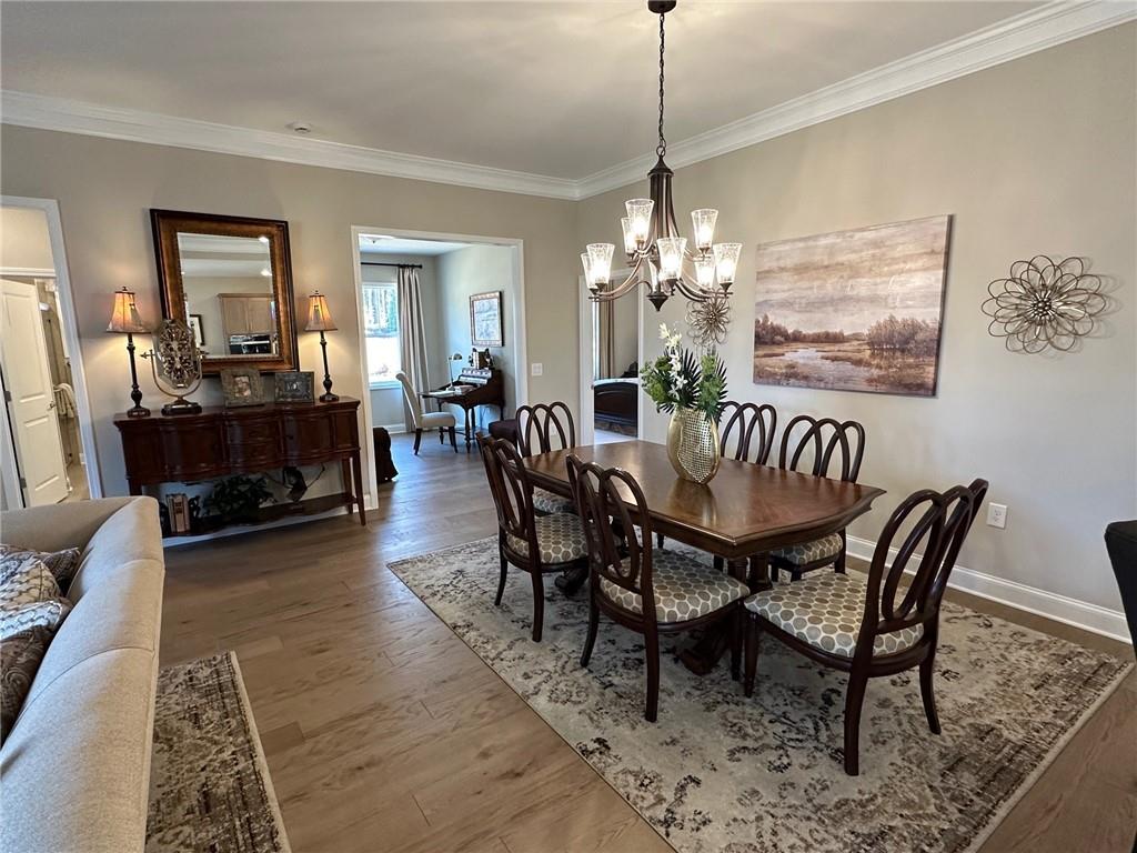 1001 Calypso Way, Unit 1001 Cumming, GA 30040 - Photo 10 of 27 a view of a dining room with furniture and chandelier