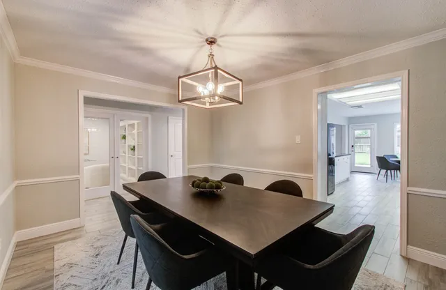 a view of a dining room with a table and chairs