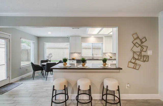 a dining room with furniture and wooden floor