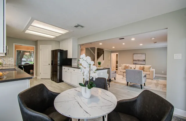 a living room with furniture and a dining table