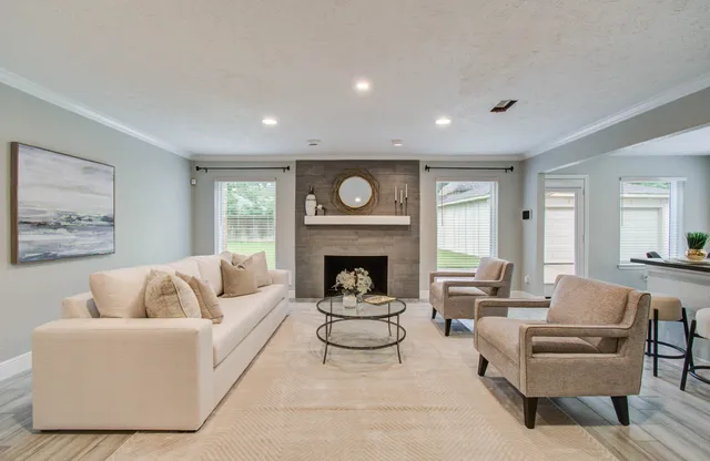 a living room with furniture and a fireplace