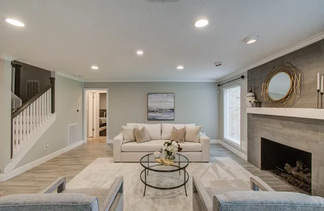 a living room with furniture and a fireplace