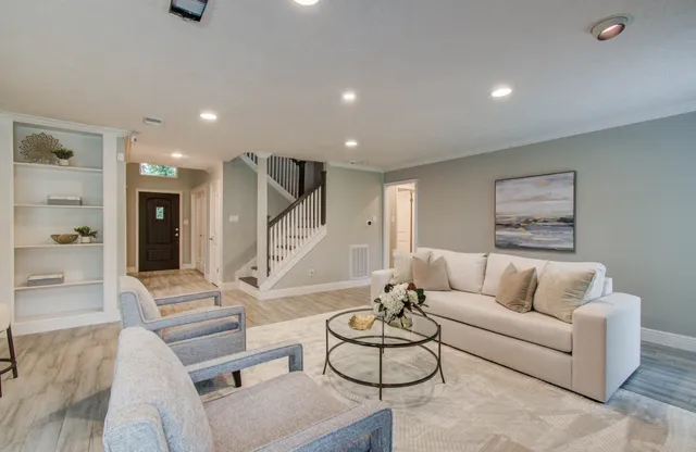 a living room with furniture and a large window
