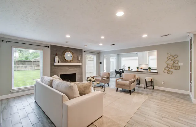 a living room with furniture and a fireplace