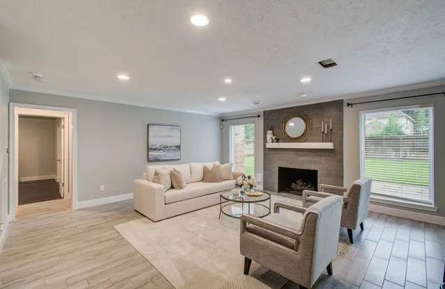 a living room with furniture and a fireplace