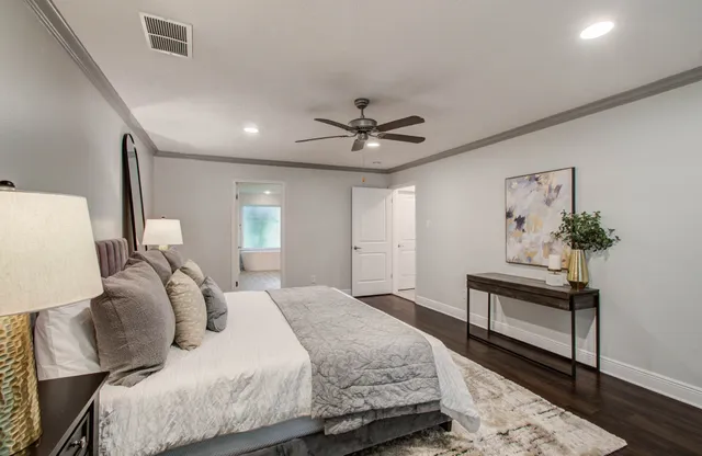 a bedroom with a bed and a chandelier