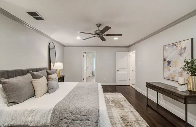 a bed room with a bed and a ceiling fan