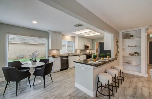 a kitchen with a table and chairs in it