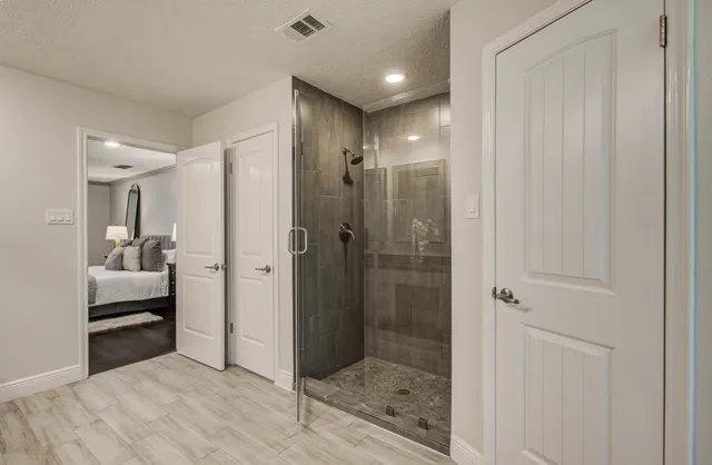 a bathroom with a shower and a sink
