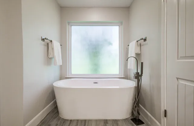 a white bath tub sitting in a bathroom