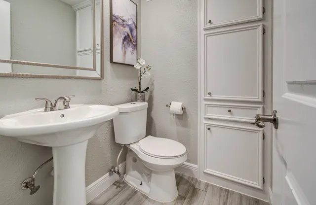 a bathroom with a toilet sink and mirror
