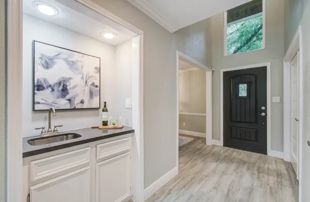 a room with furniture and paintings on the wall