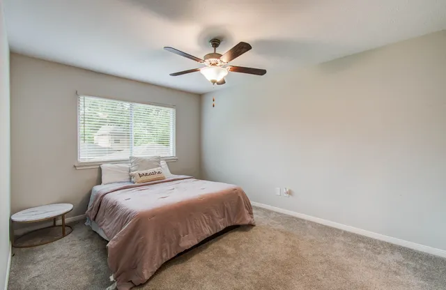a bedroom with a bed and a window