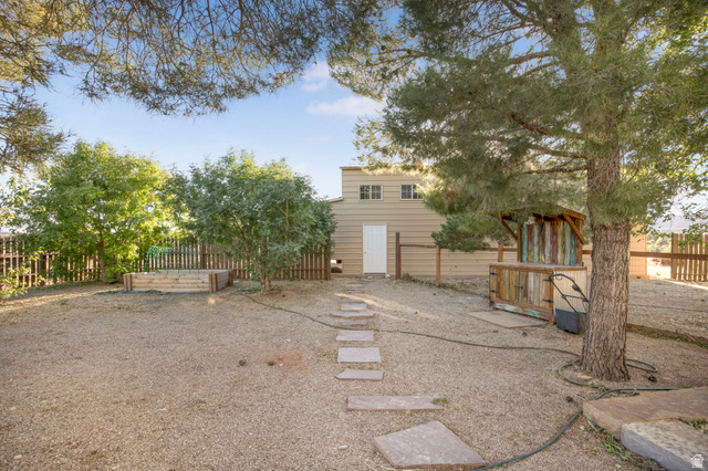 1440 West 100 South Virgin, UT 84779 - Photo 34 of 45 Expansive gravel yard featuring mature trees and a fenced perimeter