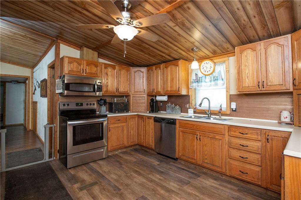 9133 South Watson Run Road Meadville, PA 16335 - Photo 6 of 45 a kitchen with stainless steel appliances granite countertop a stove a sink dishwasher and a microwave oven with cabinets