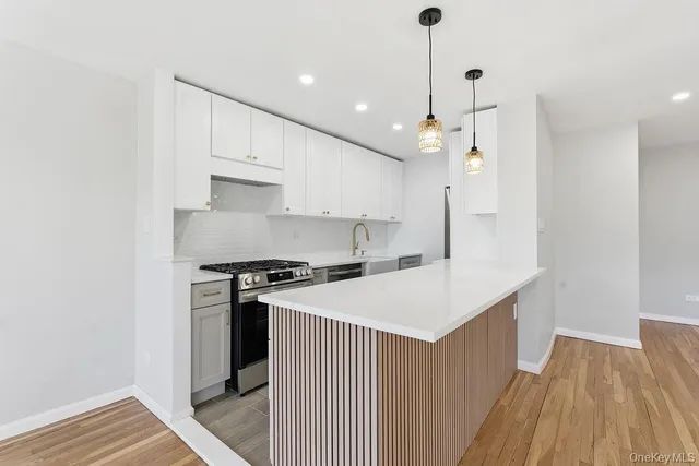a kitchen that has a sink stainless steel appliances a counter space and a window