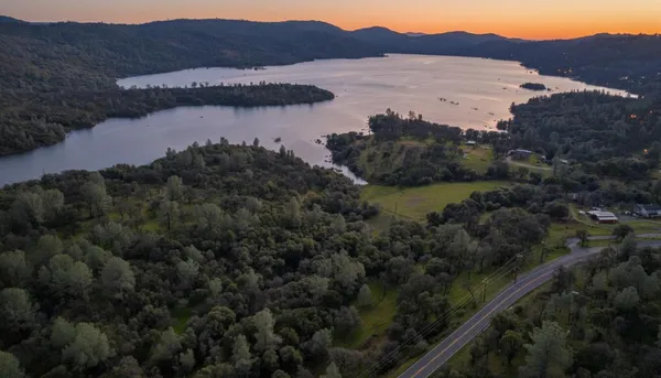 a view of a lake in middle of the forest