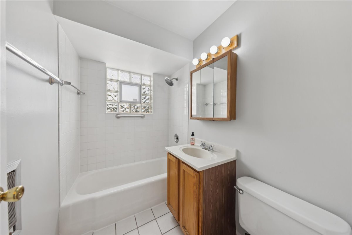 6862 West Lode Drive, Unit 2A Worth, IL 60482 - Photo 9 of 14 a bathroom with a sink a toilet and shower