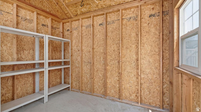 2038 East Ranch Road Eagle Mountain, UT 84005 - Photo 43 of 66 Storage shed interior with exposed wood framing, oriented strand board walls, and concrete flooring