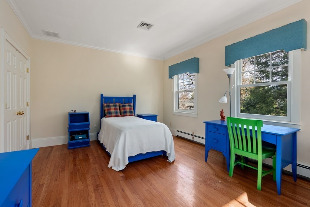 26 Robin Road Weston, MA 02493 - Photo 24 of 42 a bedroom with a bed and a table