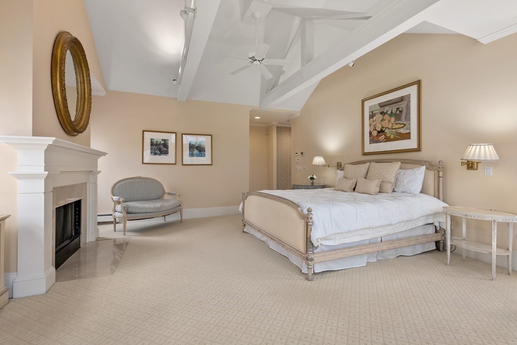 26 Robin Road Weston, MA 02493 - Photo 31 of 42 a spacious bedroom with a bed and a chandelier