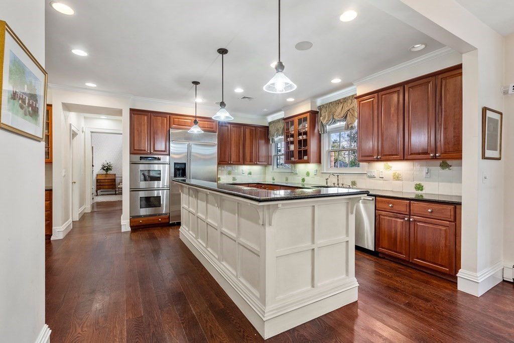 26 Robin Road Weston, MA 02493 - Photo 8 of 42 a kitchen with stainless steel appliances kitchen island granite countertop wooden floors wooden cabinets and window