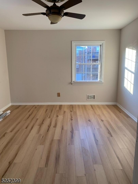31 Morgan Lane, Unit 2A Bridgewater, NJ 08807 - Photo 9 of 12 an empty room with wooden floor and windows