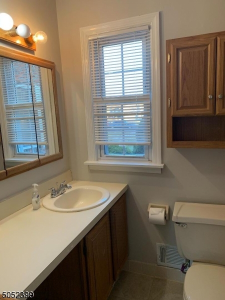 31 Morgan Lane, Unit 2A Bridgewater, NJ 08807 - Photo 10 of 12 a bathroom with a sink a toilet and a mirror