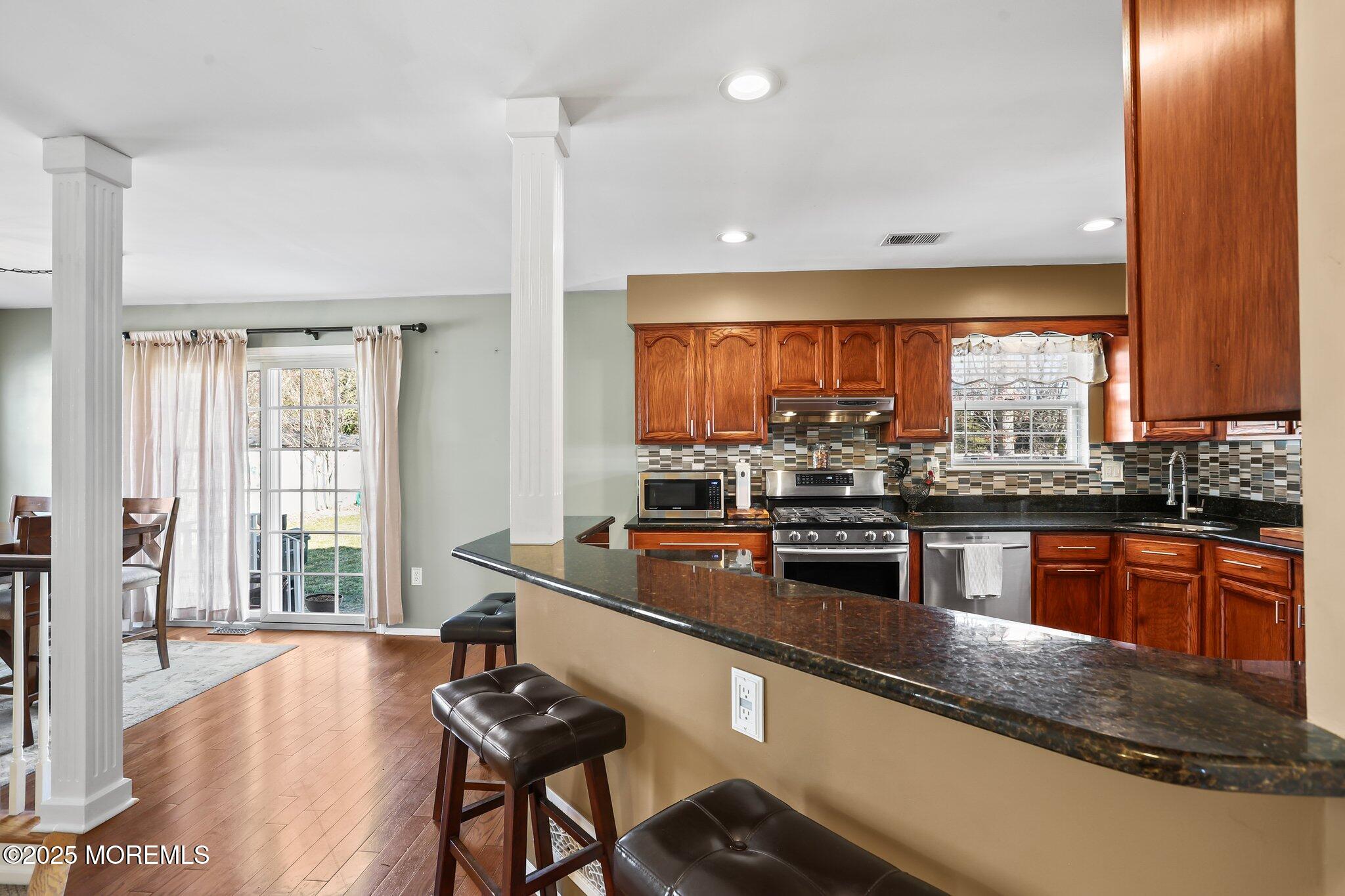 21 Sun Hollow Road Howell, NJ 07731 - Photo 11 of 47 a kitchen with stainless steel appliances granite countertop a stove a sink and a microwave