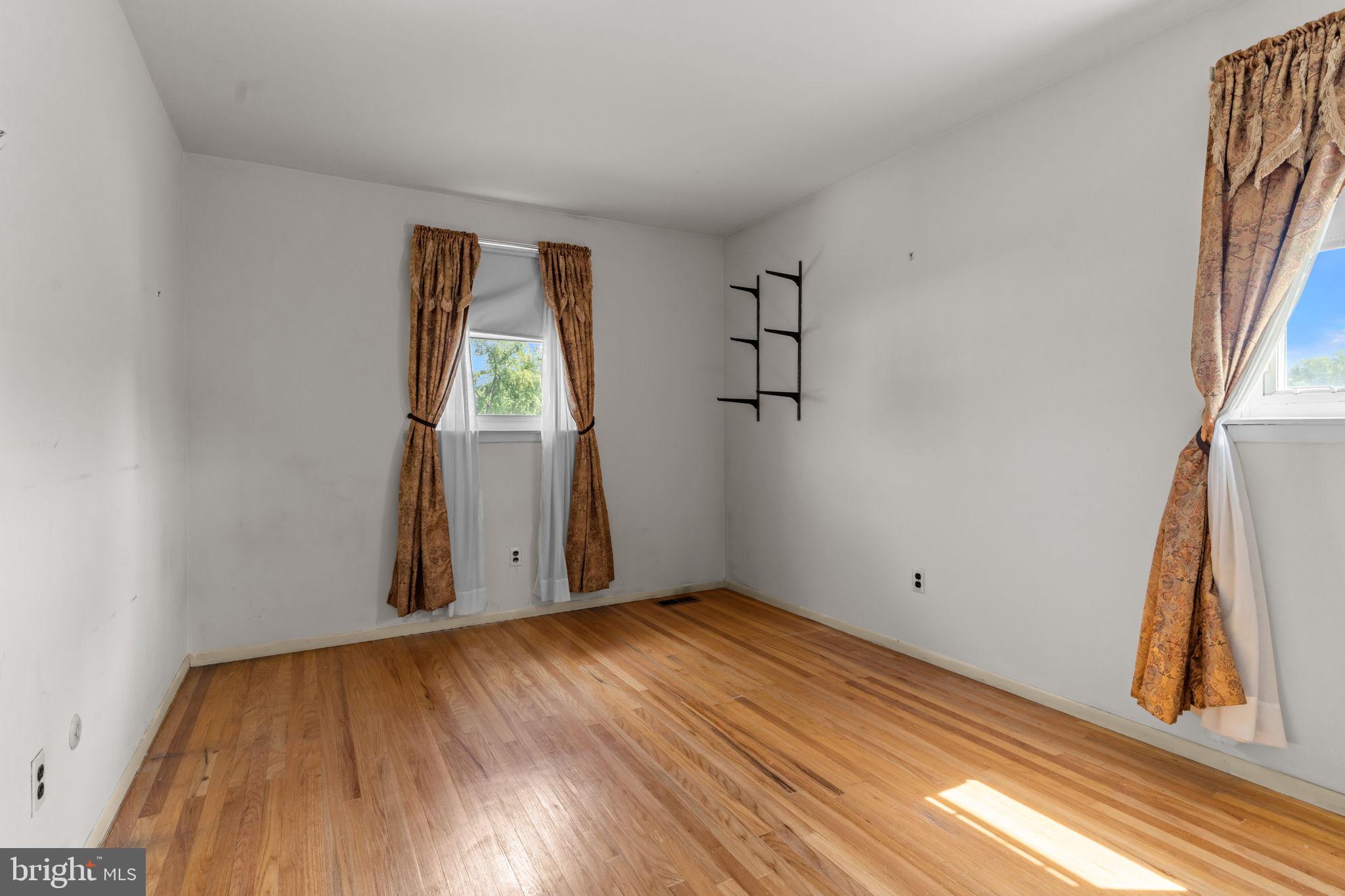 110 Linda Avenue Delran, NJ 08075 - Photo 19 of 26 an empty room with wooden floor and windows