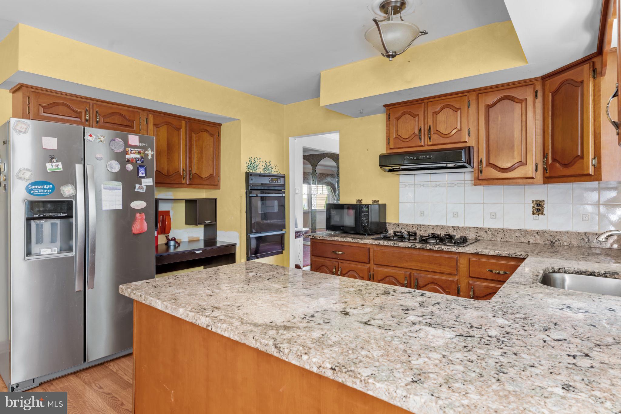110 Linda Avenue Delran, NJ 08075 - Photo 5 of 26 a kitchen with stainless steel appliances granite countertop a sink stove and refrigerator