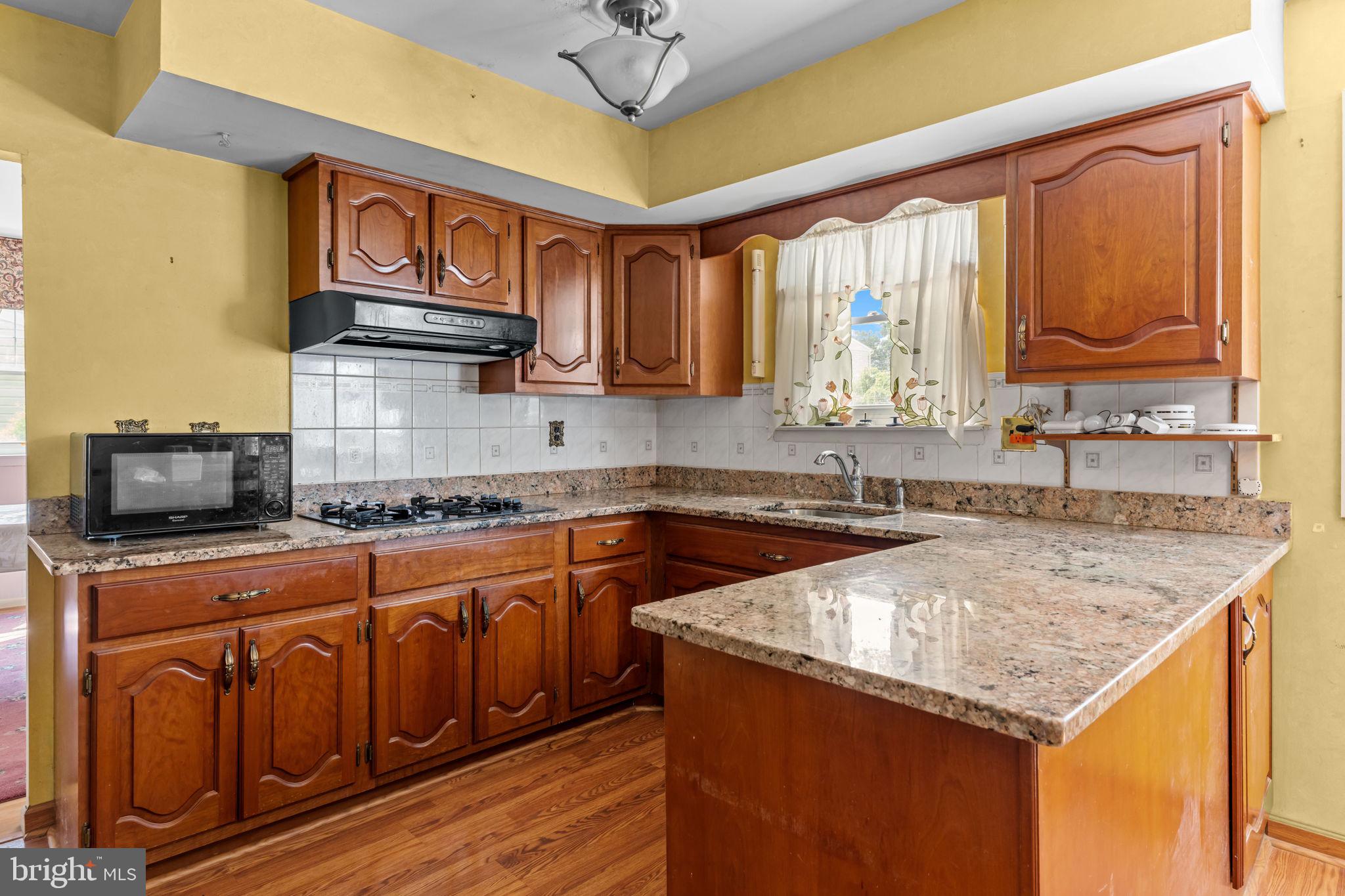110 Linda Avenue Delran, NJ 08075 - Photo 6 of 26 a kitchen with stainless steel appliances granite countertop a sink stove and cabinets