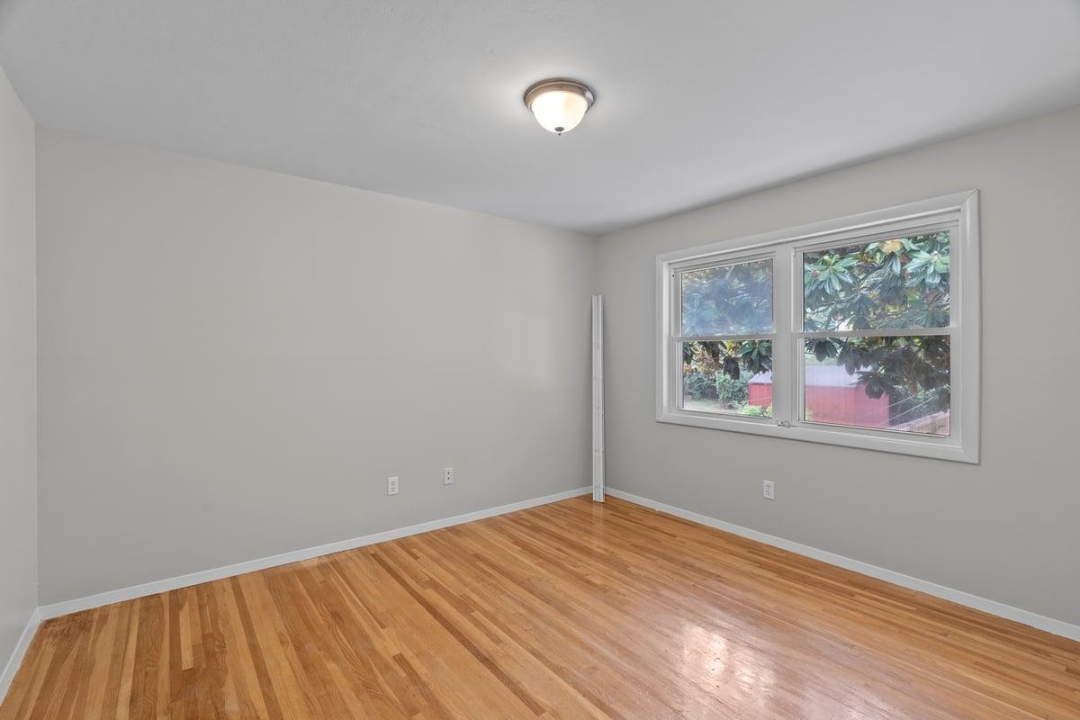3221 East Raines Road Memphis, TN 38118 - Photo 23 of 28 Empty room featuring baseboards and light wood finished floors