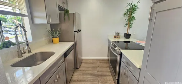 a kitchen with a sink and a refrigerator