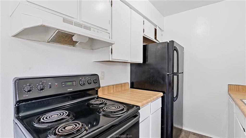2712 Evergreen Circle Bryan, TX 77801 - Photo 19 of 30 Kitchen with white cabinetry and black appliances