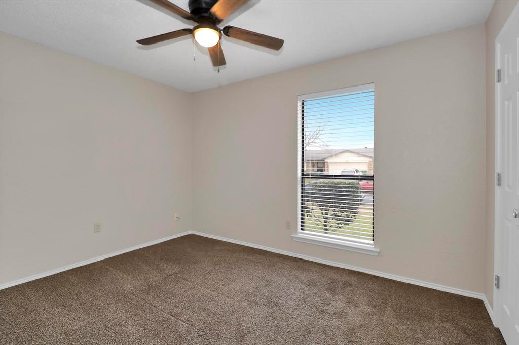 6632 Valley View Drive Watauga, TX 76148 - Photo 15 of 18 an empty room with a window and a ceiling fan