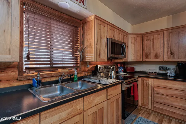 a kitchen with granite countertop a sink and a stove