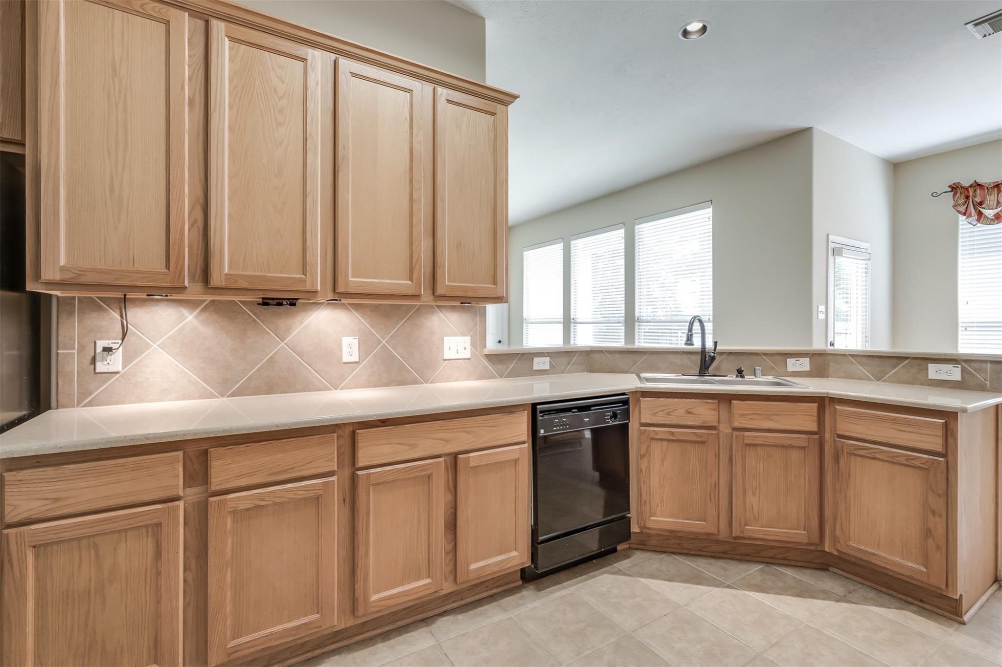3419 La Fleur Lane Spring, TX 77388 - Photo 12 of 26 a kitchen with white cabinets and sink
