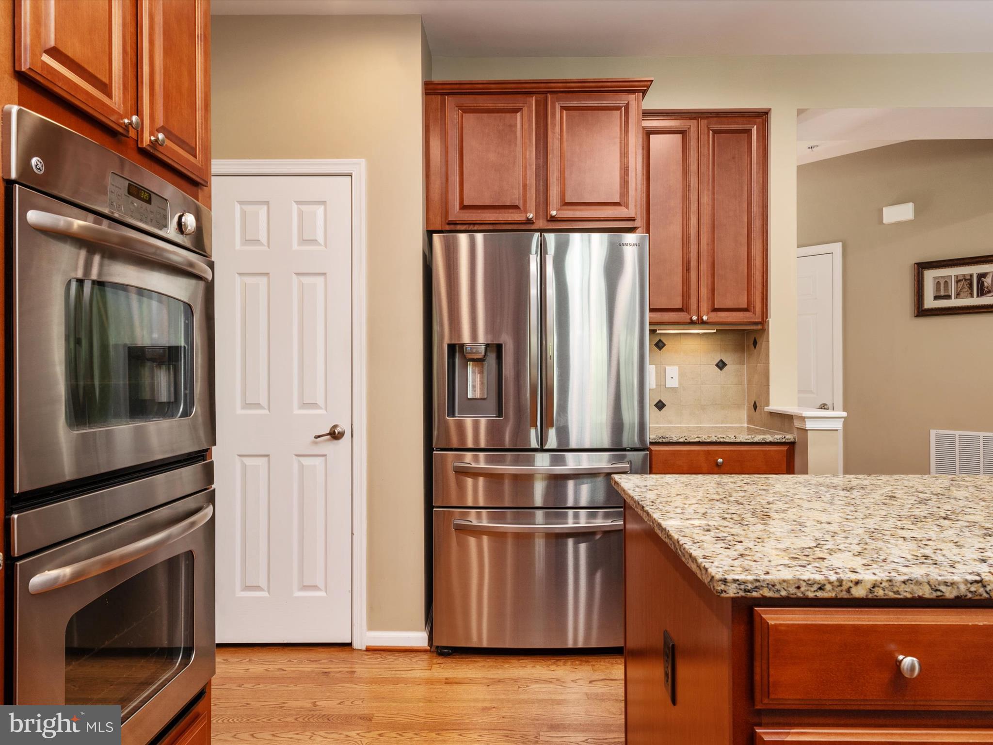 10518 Windlass Run Road Baltimore, MD 21220 - Photo 19 of 71 a kitchen with granite countertop a refrigerator stove and microwave