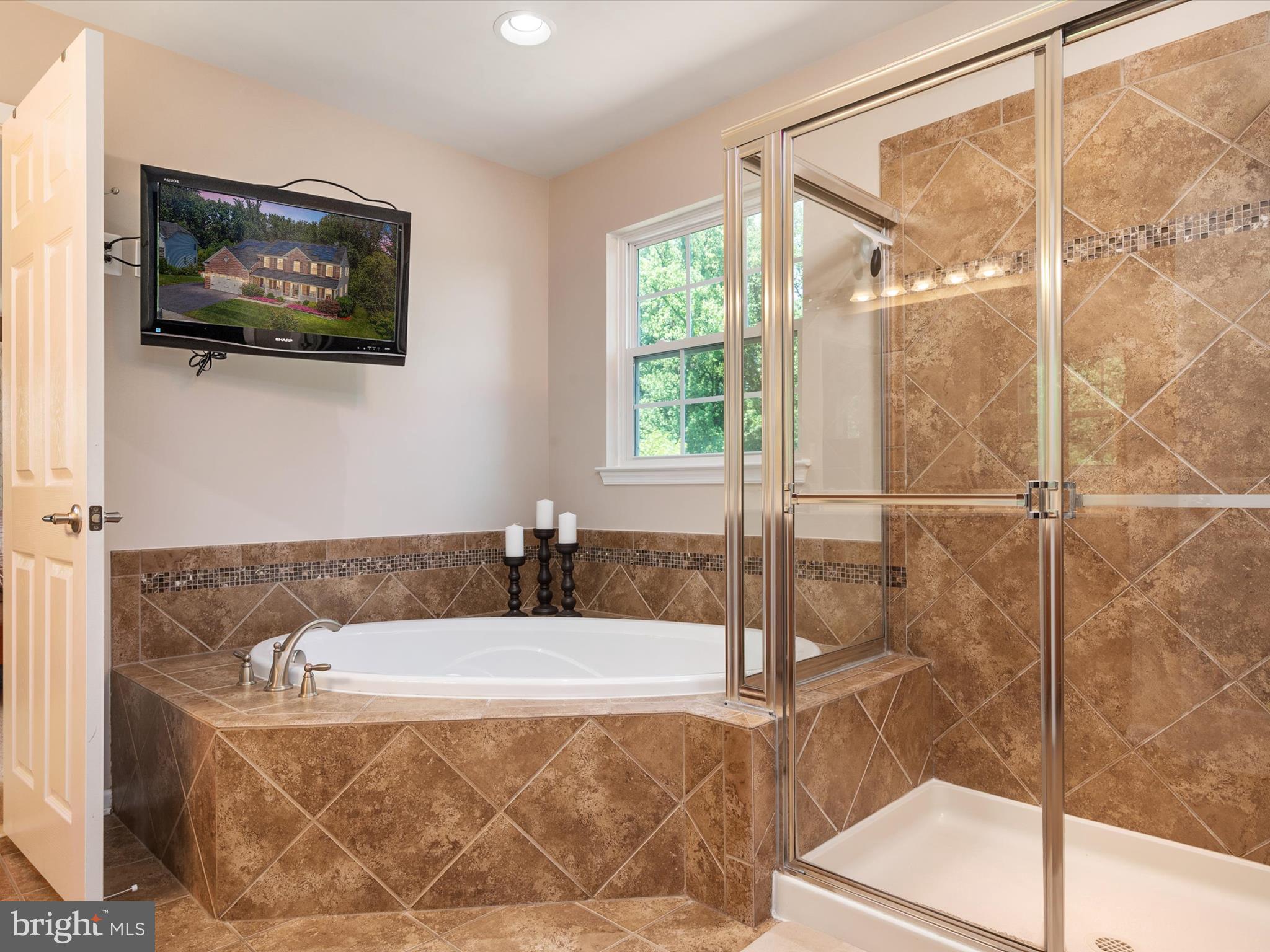 10518 Windlass Run Road Baltimore, MD 21220 - Photo 37 of 71 a bathroom with a tub a mirror and a shower