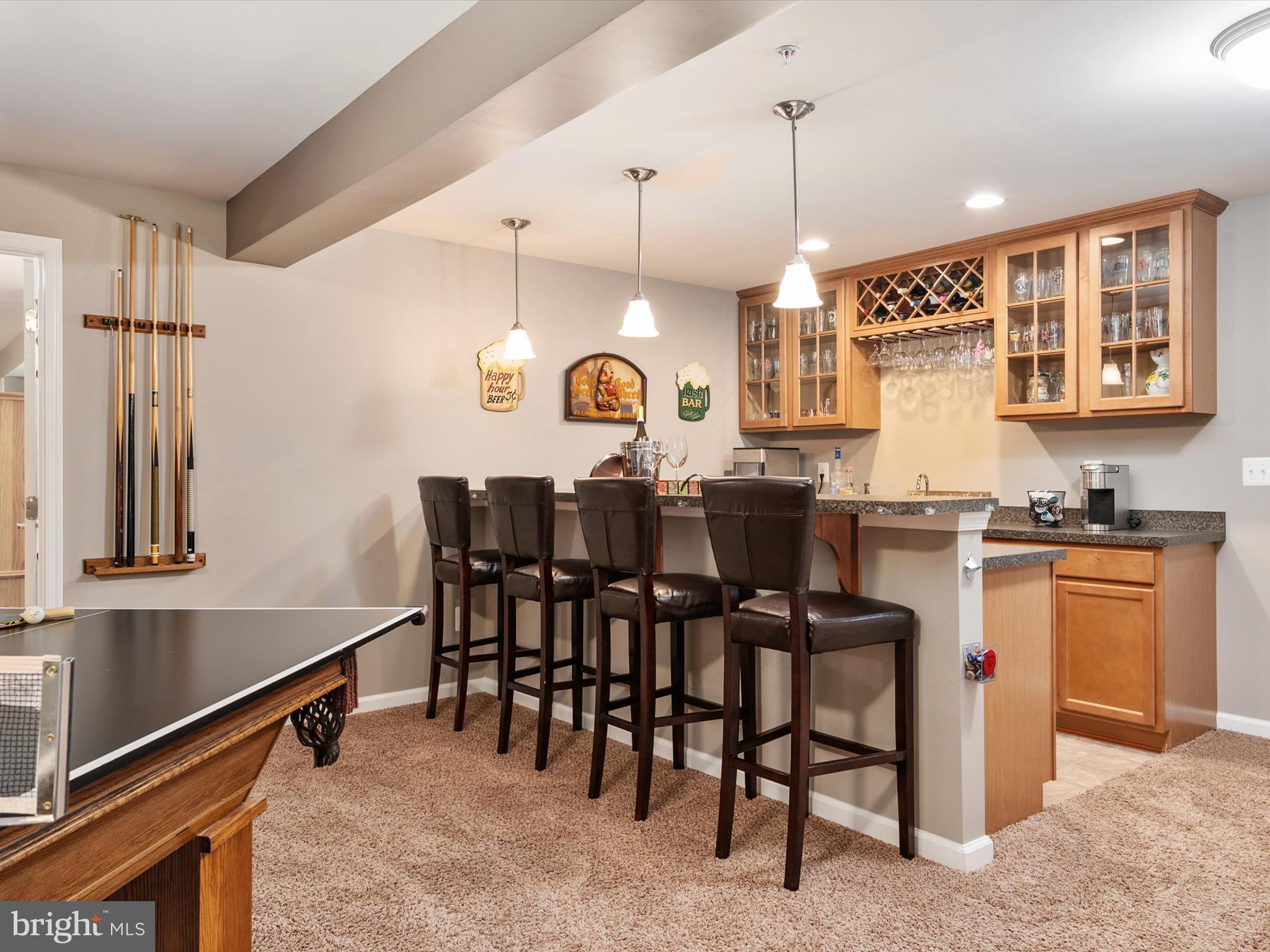 10518 Windlass Run Road Baltimore, MD 21220 - Photo 53 of 71 a kitchen with granite countertop cabinets a dining table and chairs