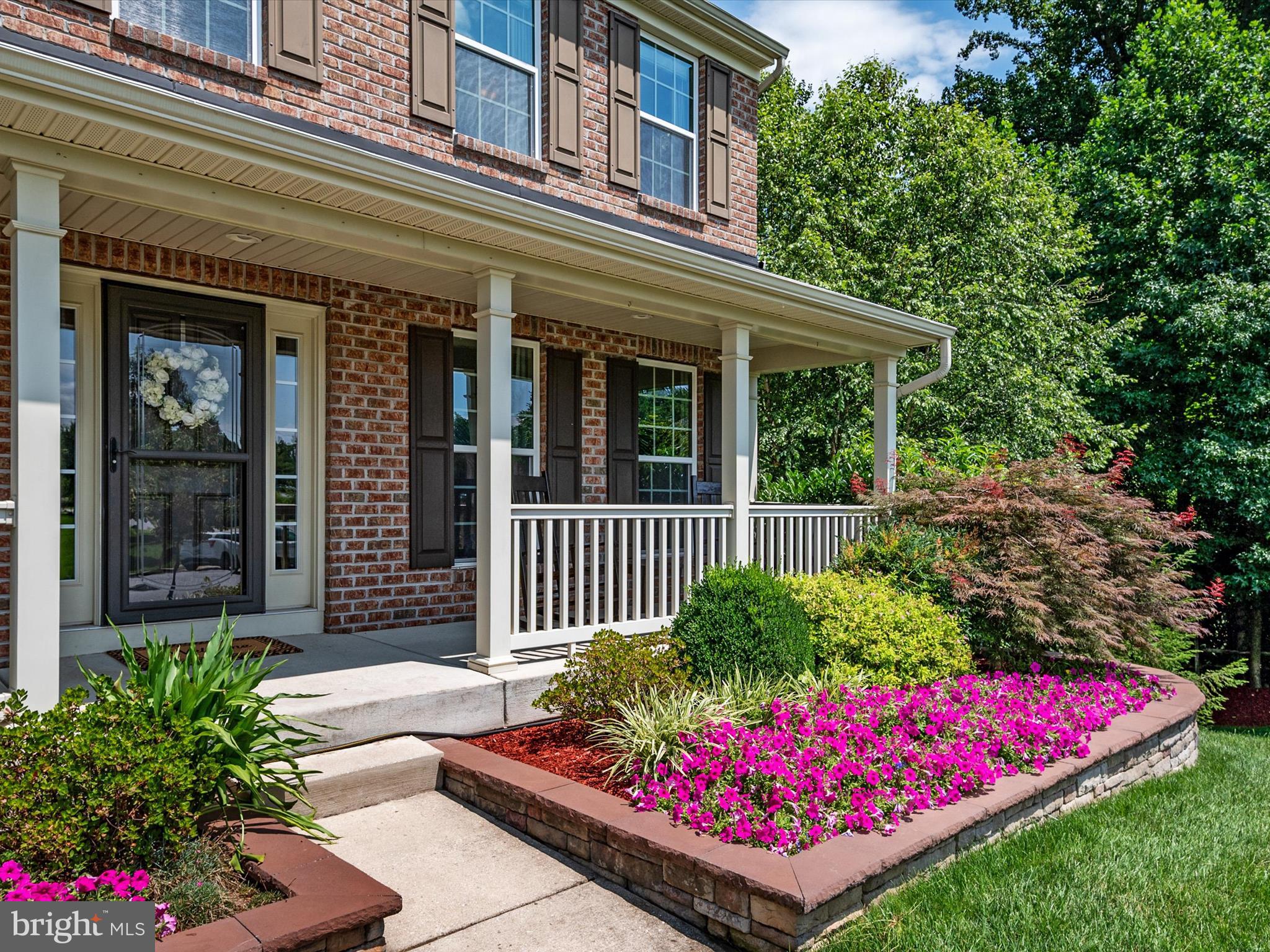 10518 Windlass Run Road Baltimore, MD 21220 - Photo 9 of 71 front view of a house with a flower garden