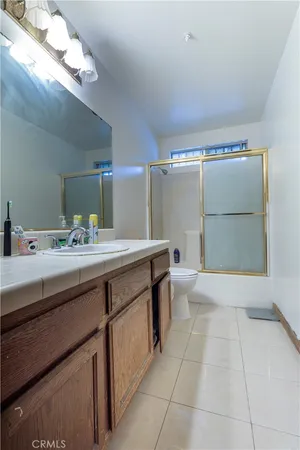 a bathroom with a sink a toilet and mirror