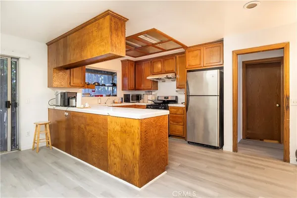 a kitchen with refrigerator cabinets and a sink